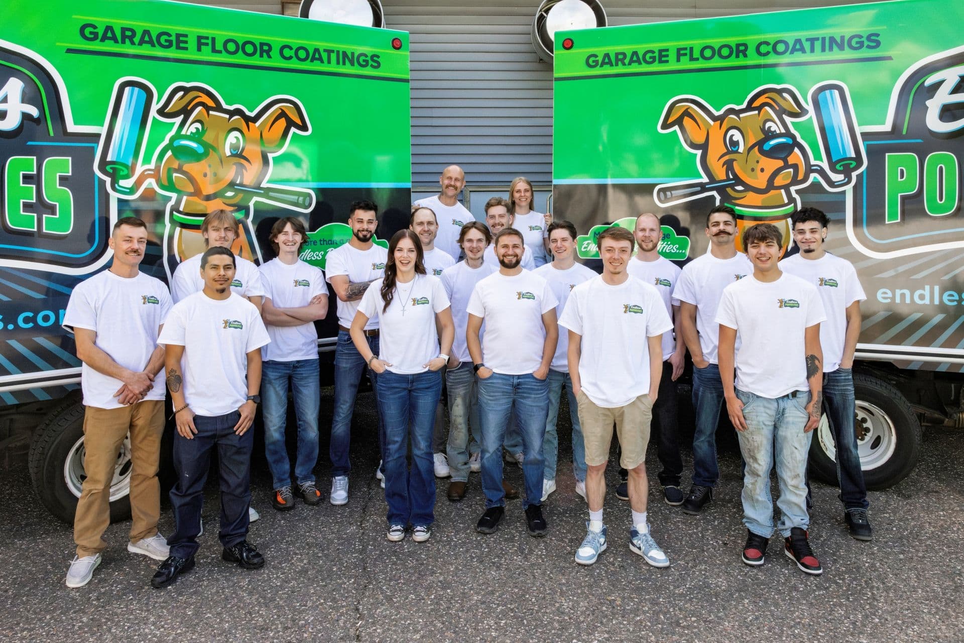 The Endless Poxybilities team stands in front of branded trucks.