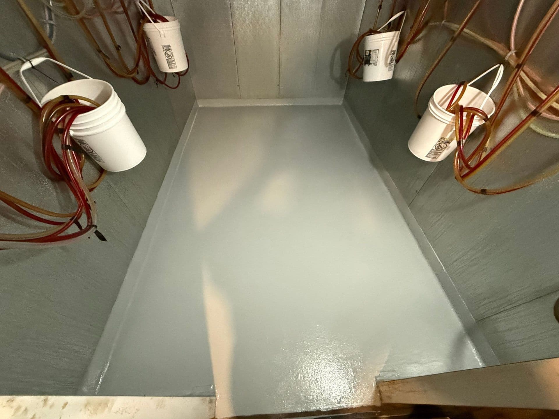 A restaurant beer cooler with newly-coated gray concrete floor.