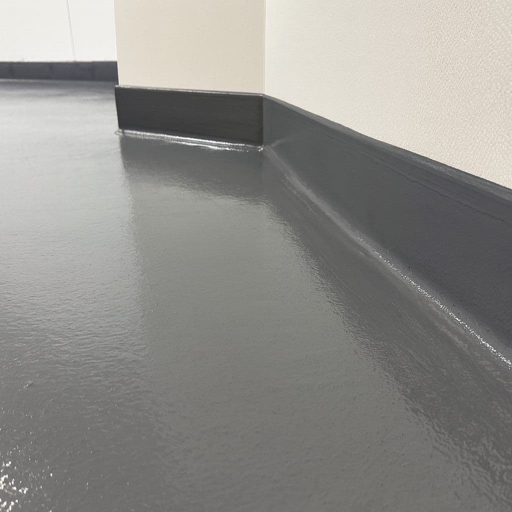 A close-up of dark gray urethane cement flooring.