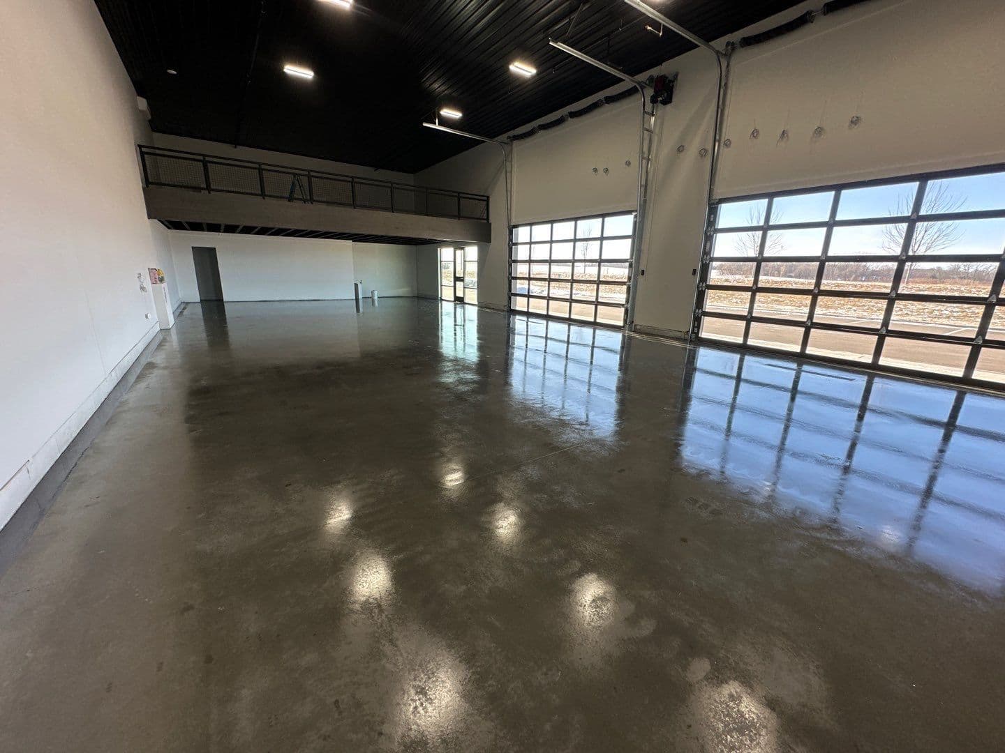 A commercial retail showroom with newly-coated Grind and Seal dark gray flooring.