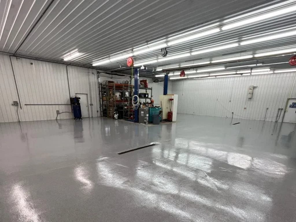A commercial warehouse space with a newly-coated concrete flooring.