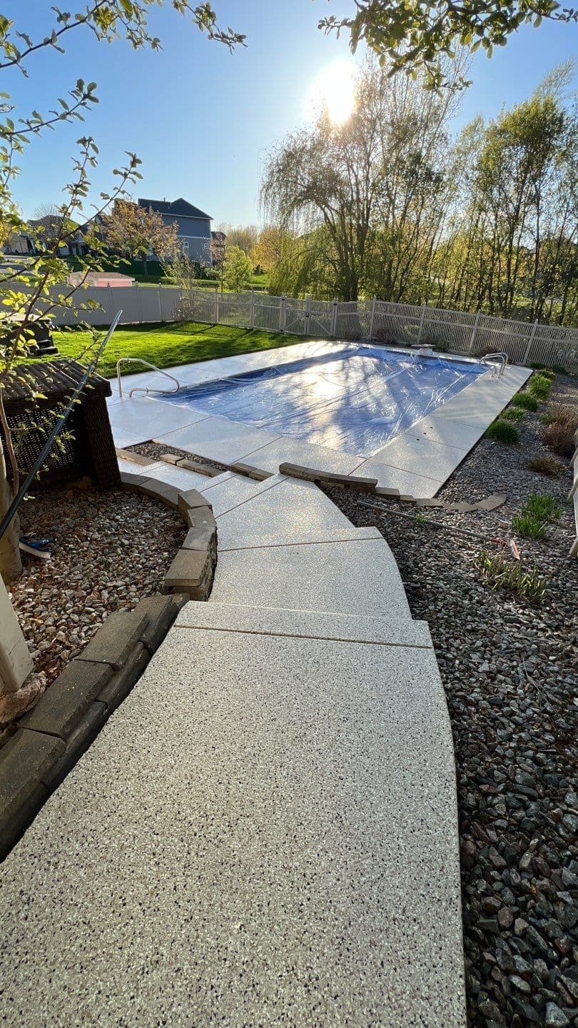 A newly-coated flake pool deck and walkway.