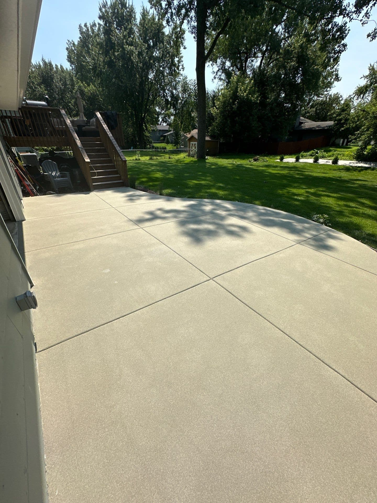 A light, solid-colored concrete coated Resist patio.
