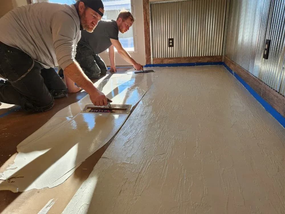 The Endless Poxybilities team works to install a concrete coating floor.